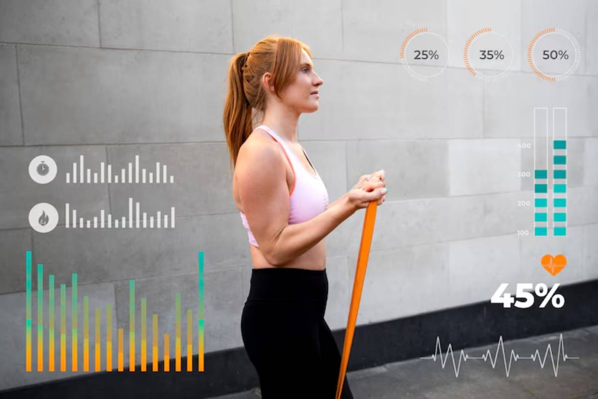 A person holds an orange resistance band against a gray wall, with fitness metrics and graphs displayed around them.